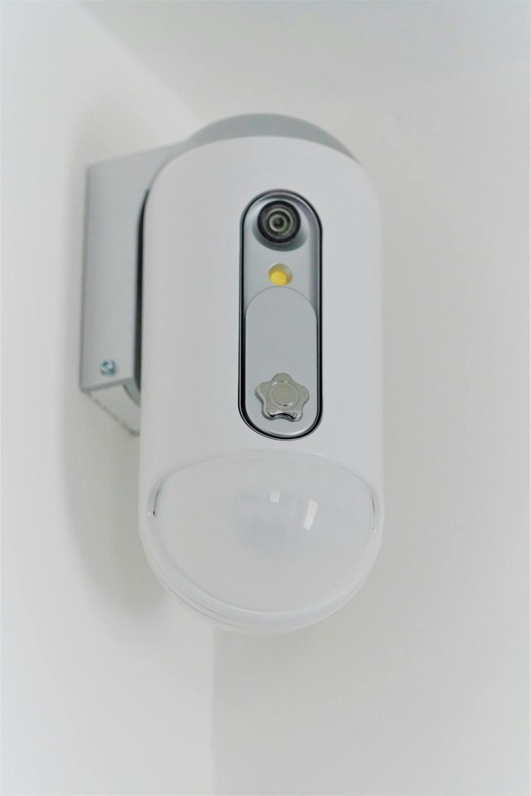 Close-up view of a contemporary indoor surveillance camera mounted on a wall for security monitoring.